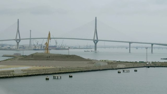 Bay of Cadiz with new construction site of the commercial port and the Constitution of 1812 Bridge or La Pepa Bridge.