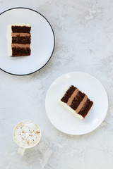 Slices of chocolate cake on a gray table. Vertical orientation, top view.
