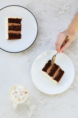 Slices of chocolate cake on a gray table. Vertical orientation, top view.
