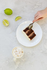 A piece of chocolate cake with a cup of coffee on the table.