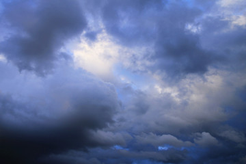 Naklejka na ściany i meble Blue sky with dark clouds