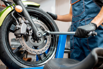 Fototapeta premium Repairing motorcycle at the workshop