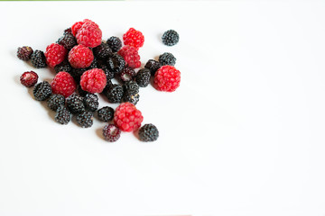 Black and red raspberry composition on a white background.