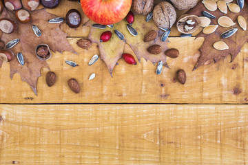 Autumn composition with fresh fruits, nuts and leaves
