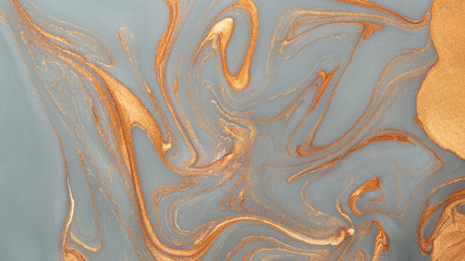 Abstract gold silver sparkling glitter background with mother-of-pearl marble metallic veins.