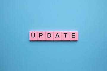 Update word wooden cubes on blue background