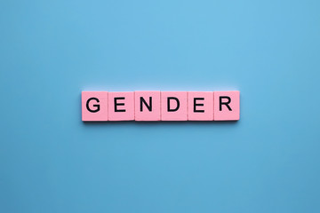 Gender word wooden cubes on blue background