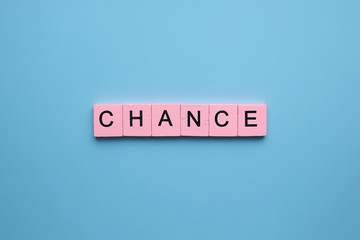 Chance word wooden cubes on blue background