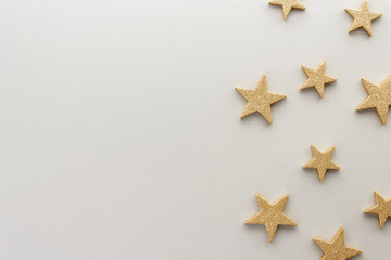 Christmas composition. Golden stars on white background top view background top view background with copy space for your text. Flat lay.