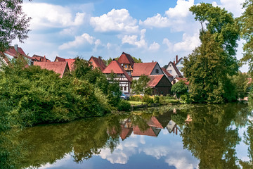 Obraz premium Grouping of beautiful traditional houses on the Wörnitz riverbank. Photography taken in Dinkelsbühl, Bavaria, Germany.