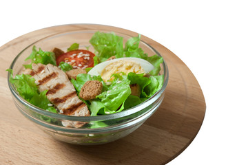 Caesar salad with grill chicken fillet isolated on white background