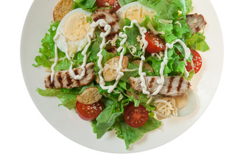 Caesar salad with grill chicken fillet isolated on white background