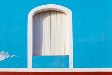white wooden window in blue facade, trinidad - cuba