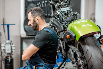 Fototapeta na wymiar Biker with motorcycles in the garage