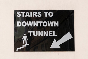 sign stairs to downtown tunnel  with arrow