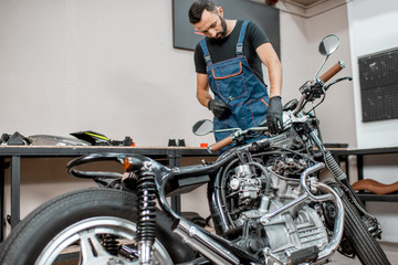 Repairing motorcycle in the workshop