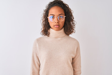Young brazilian woman wearing turtleneck sweater and glasses over isolated white background with a...