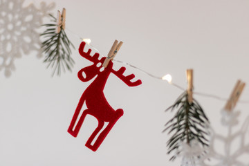 Christmas decor, decorative handmade white snowflakes and Santa's felt deer, hanged on led stripes