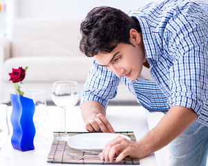 Man alone preparing for romantic date with his sweetheart