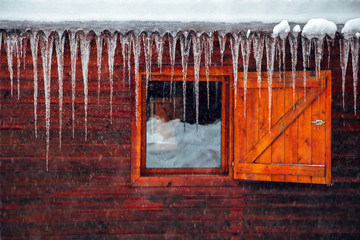 Icicles. View from a cottage window in heavy winter in the mountains.