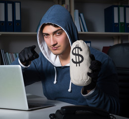 The young hacker hacking into computer at night