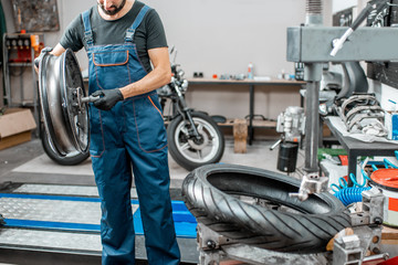 Worker changing a motorcycle tire