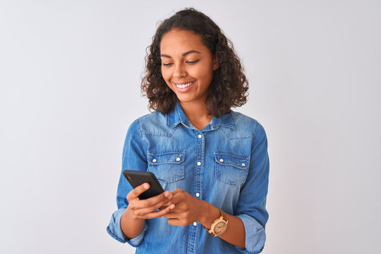 Young Brazilian Woman Using Smartphone Standing Over Isolated White Background With A Happy Face Standing And Smiling With A Confident Smile Showing Teeth