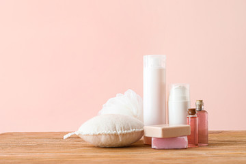 Cosmetics with bast wisps on wooden table