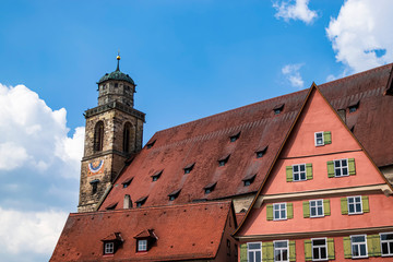 Fototapeta premium Detail of the bell tower as well as its roof and part of the facade of the Church of Münster St. Georg Dinkelsbühl. Photography taken in Dinkelsbühl, Bavaria, Germany.