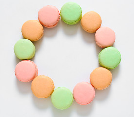 Tasty macarons on white background