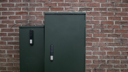 Electric distribution box isolated green brick wall empty mockup