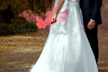 bride and groom for a walk. The concept of marriage, family relationships, wedding paraphernalia.