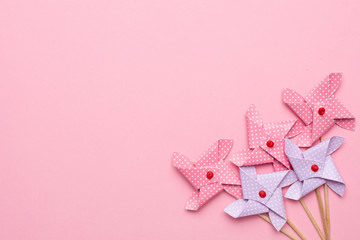 Blue and pink paper windmill pinwheel on pink background, Circus, Childhood, Festival, Party, Fun, joy, Happines.