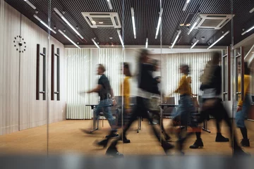 Fotobehang Group of office employees at coworking center. Business people walking at modern open space. Motion blur. Concept © leonidkos