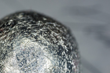 Unusual abstract techno view of crumpled aluminum foil ball, close-up, macro photography