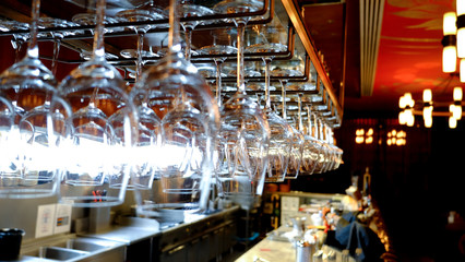 Fototapeta na wymiar Selective focus of hang wine glasses row in the restaurant 