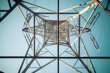 Close up of electrical tower and blue sky. Renewable energy and smart grid.