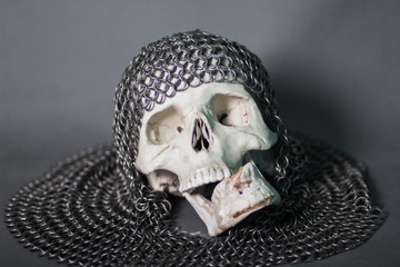 The human skull in the chainmail hood. The remains of a fallen warrior. Death.