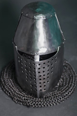 Knight's helmet and chainmail hood. Gray background. Topfhelm. Coif.