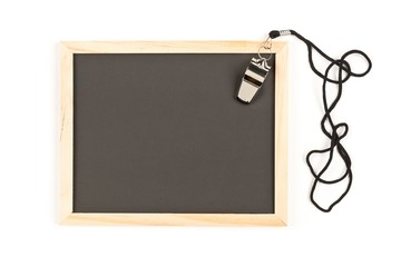 Soccer sports referee chrome whistle on empty, blank blackboard background with copy space over white