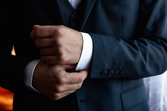 Hands of a businessman, closeup, button sleeves on a shirt.