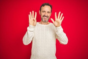 Naklejka premium Handsome middle age senior man with grey hair over isolated red background showing and pointing up with fingers number nine while smiling confident and happy.