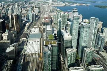 Fototapeta premium Aerial view of Toronto City Skyscrapers, Looking northeast from top of CN Tower toward East York and Scarborough districts in summer, Union Station at bottom right. Toronto City, Ontario, Canada