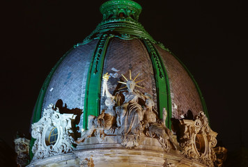 Night view of sitting statue of liberty. Building of former Galician Savings Bank, now it is a Museum of Ethnography and Art Crafts In Lviv, Ukraine.