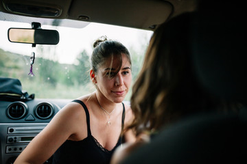 Fototapeta na wymiar Two young lesbians enjoying inside a car