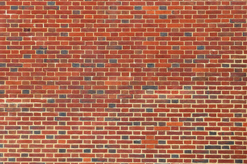 Close up view on aged and weathered red brick wall textures in high resolution