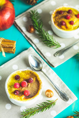 Christmas and New Year composition with sweet delicious apples dessert, spruce branches, cutlery on blue turquoise wooden table surface, copy spice