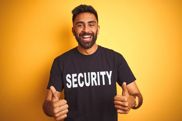 Arab indian hispanic safeguard man wearing security uniform over isolated yellow background success...