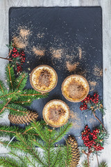 Eggnog with cinnamon and nutmeg for Christmas and winter holidays. Homemade eggnog in glasses with spicy rim on blackstone board, shallow depth of the field, top view, copy space