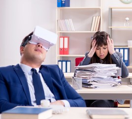 Employee with virtual reality glasses in office